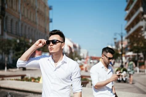 Una pareja gay asiática camina por la calle mirando los lugares de interés y pasándose un buen