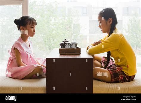 Sisters Sitting Cross Legged Side By Side Hi Res Stock Photography And