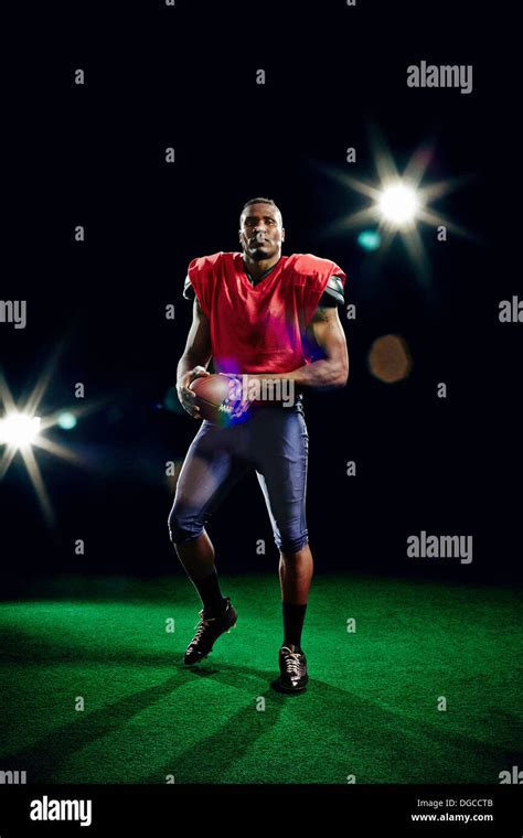 American Football Player Holding Ball Stock Photo Alamy