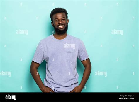 African Man Laughing Against Turquoise Background Stock Photo Alamy
