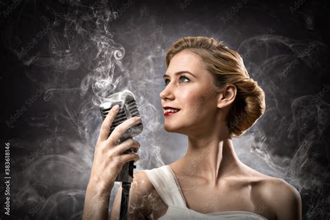 Beautiful Blonde Woman Singer With A Microphone Stock Photo Adobe Stock