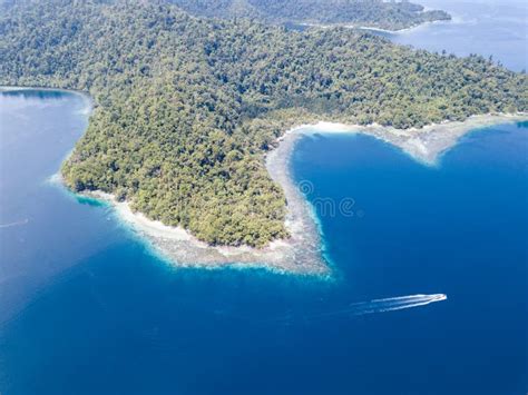 Aerial Of Beautiful Island And Fringing Reef In Raja Ampat Stock Photo