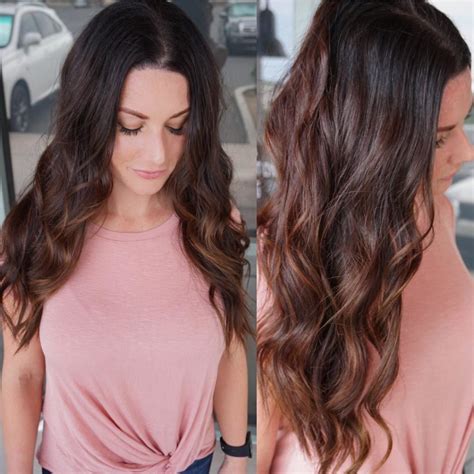 Long Brunette Wavy Layered Cut With Warm Toned Highlights The Latest