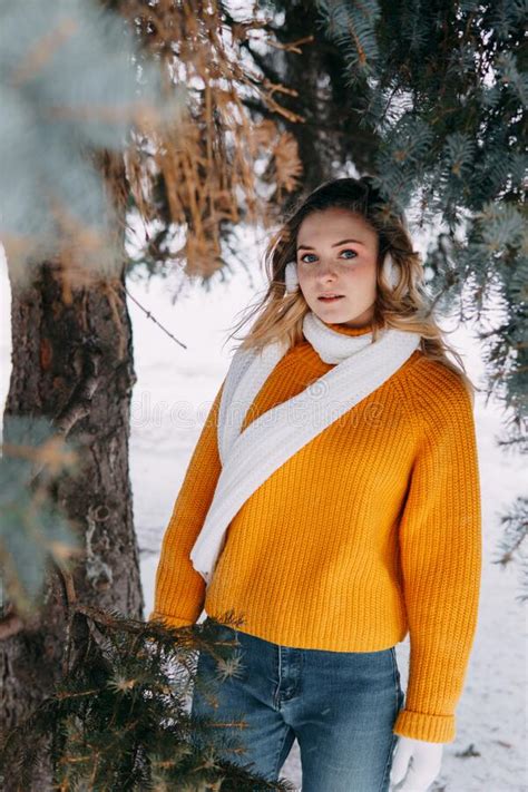 Teen Blonde In A Yellow Sweater Outside In Winter A Teenage Girl On A Walk In Winter Clothes In