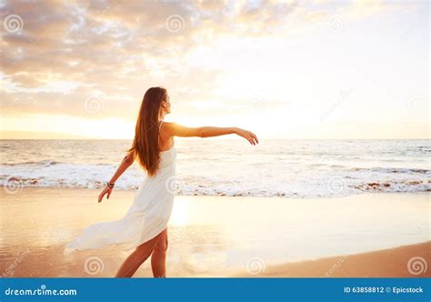 Happy Carefree Woman On The Beach At Sunset Stock Photo Image Of