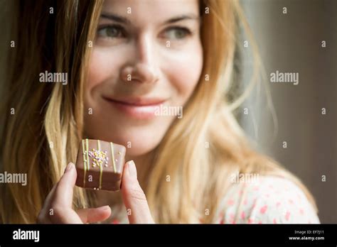 Woman Eating A Chocolate Stock Photo Alamy