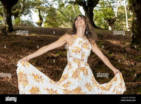 Serenity Amidst Nature Radiant Brunette In A Long Summer Dress Embraces The Forest S Bliss