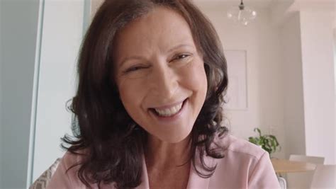 Beautiful Mature Woman Having Video Chat Using Webcam At Home Grandmother Waving Hand Chatting