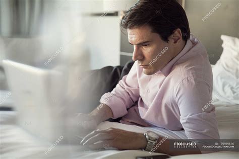 Man using laptop computer in bed — Three Quarter Length, 35 39 years ...