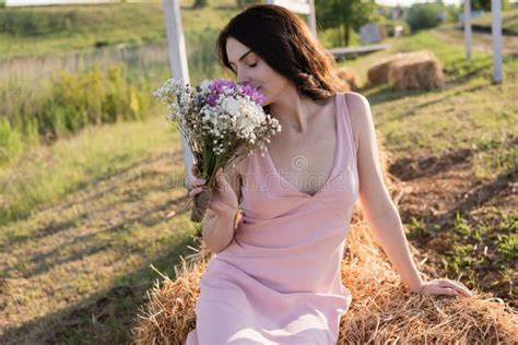Brunette Woman With Closed Eyes Sitting Stock Photo Image Of Flowering Pink 254033166