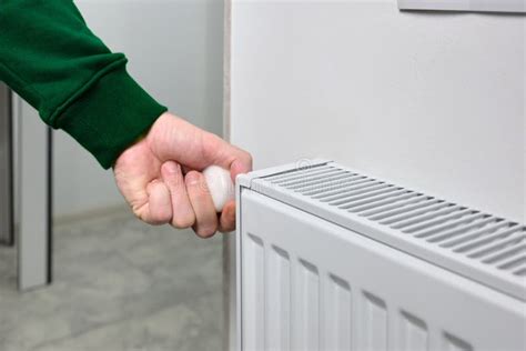 A Man Opens A Valve On A Hot Water Radiator In An Apartment Or House Stock Photo Image Of