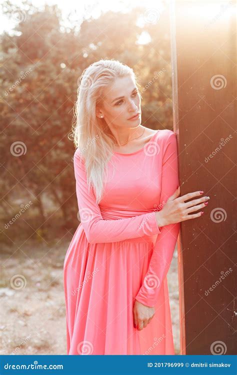 Beautiful Fashion Blonde Woman In Pink Dress Walks In The Park At Sunset Stock Image Image Of
