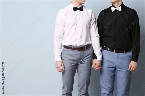 Happy Gay Couple Holding Hands Together On Color Background Stock Photo Adobe Stock