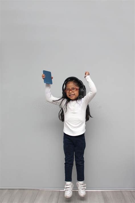 Year Old Brunette Latin Girl With Glasses Listens To Music In Her Headphones Connected To Her
