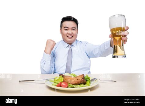 Fat Man Drinking Beer At Dinner Stock Photo Alamy