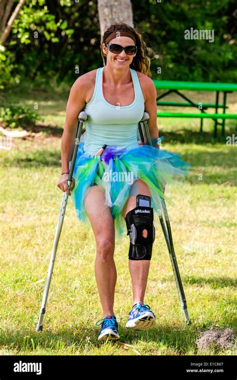 Woman Wearing A Knee Brace And Using Crutches At A Wicked Tu Tu Event