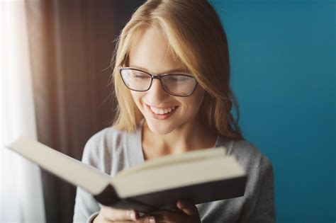 Premium Photo Blonde Reading Book At Home