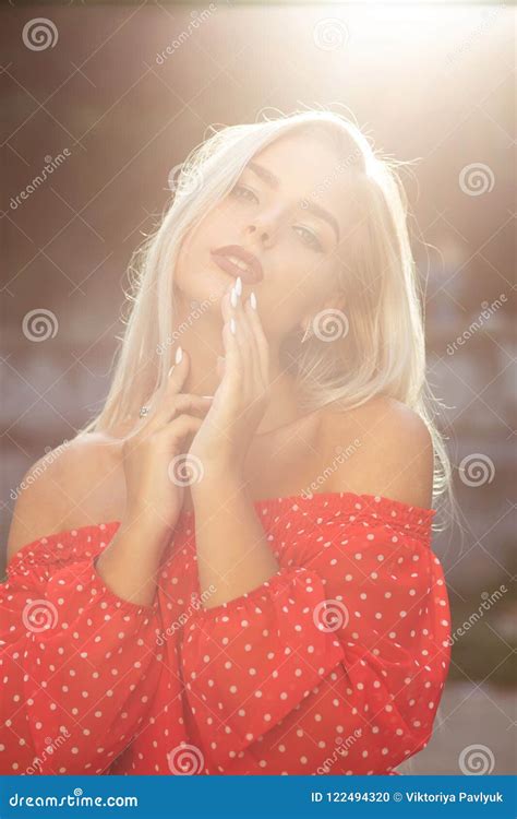 Seductive Blonde Model With Naked Shoulders In Red Dress Posing Stock Photo Image Of Bridge