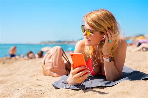Premium Photo Woman Listening To Music While Relaxing On The Beach In Hot Summer Day