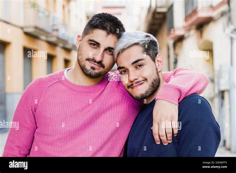 Gay Couple Smiling On Camera On City Street Male Lovers Hug Each Other Lgbt Life Style Concept