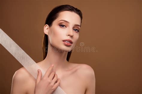 Photo Of Shiny Stunning Woman Nude Shoulders Applying Kinesio Tape Empty Space Beige Color