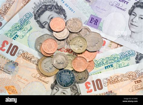 Pile Of Uk British Coins On British Bank Notes Stock Photo Alamy