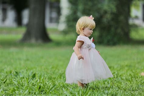 picture blonde hair toddler pretty girl lawn green grass