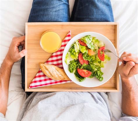 Free Photo Crop Man Eating Healthy Food On Bed