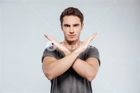 Portrait Of A Serious Casual Man Showing Crossed Arms In A Stop Gesture