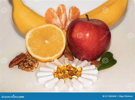Different Types Of Vitamins Fruits Nuts And Pills Stock Photo