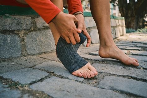 Premium Photo Latina Woman Putting Bandages On Her Feet To Protect