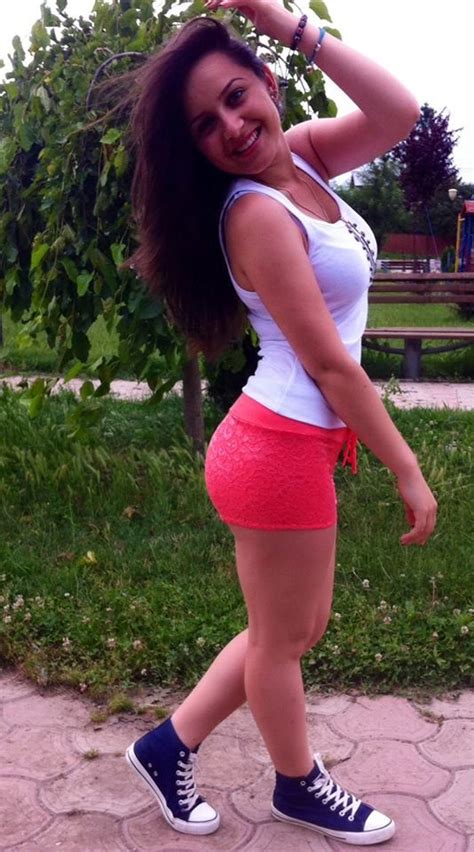 Petite Brunette Girl Smiles Showing Her Hair Style Curved Hips In White T Shirt Ted Shorts