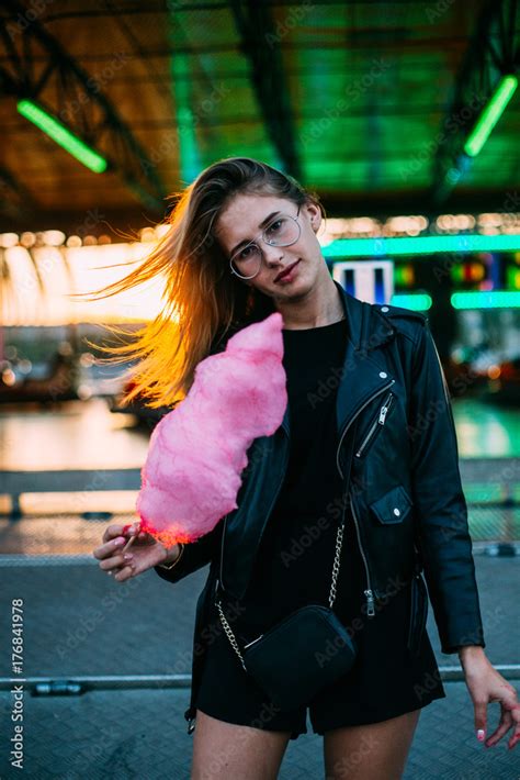 Beautiful Blonde Skinny Model Poses For Camera In Amusement Park During Summer Holidays Holds