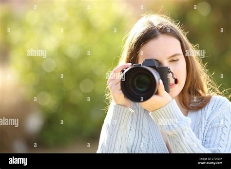Front View Portrait Of A Photographer In A Park Taking Photos With