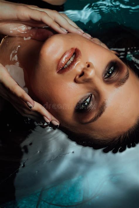 Portrait Of Beautiful Hot Woman Lies On The Water Pool Fingers Touch The Face Sexually Stock