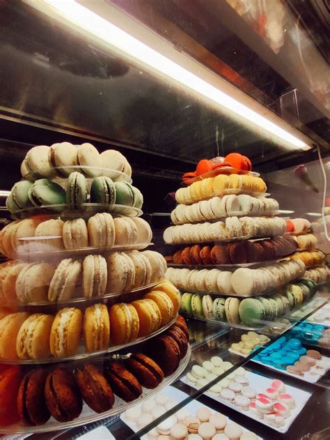 A Display Case Filled With Lots Of Different Types Of Donuts On Top Of