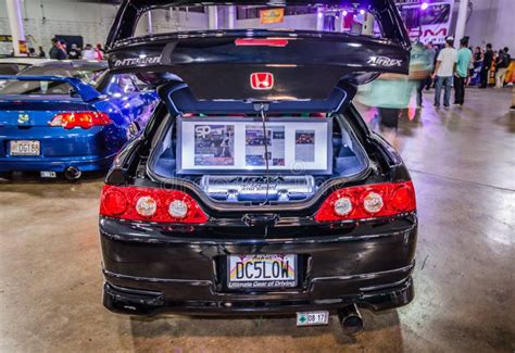 Rear View Of A Black Honda Integra With An Open Hood At Hot Import Car