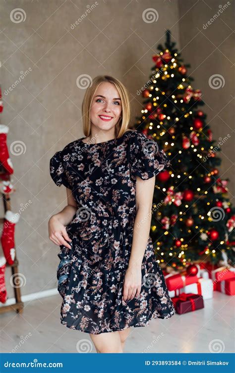 Beautiful Blonde Woman Posing In A Room With A Christmas Tree Christmas Holiday Stock Photo