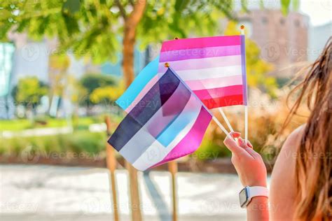 Gender Queer Woman Wave LGBTQ Gay Pride Rainbow Flags At A Pride Event Selective Focus