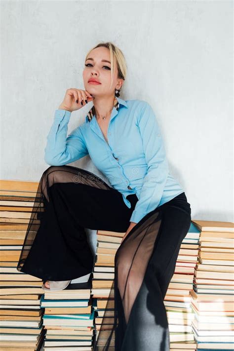 Beautiful Blonde Woman Sitting On Stacks Of Books In Library Stock Photo Image Of Leisure