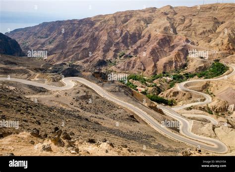 Aerial View Of Country Road Winding Through The Jordanian Desert