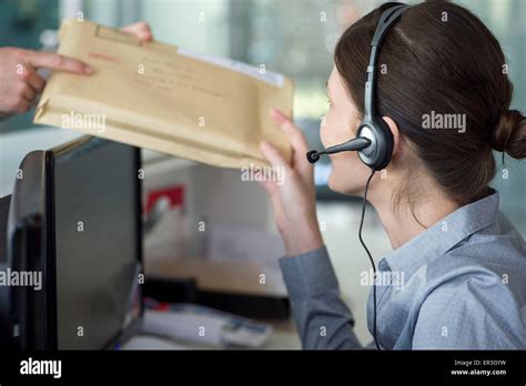Receptionist Receiving Mail From Delivery Person Stock Photo Alamy