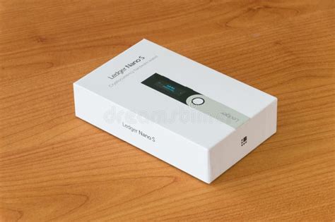 Box with Leger Nano S on Wooden Table. Ledger Nano S is Cryptocurrency ...