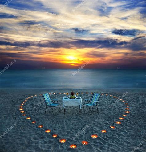 Romantic dinner on sea beach with candles Stock Photo by ©EM_prize 24547163