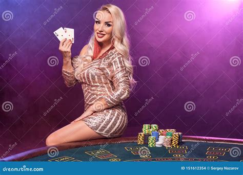 Blonde Woman With A Perfect Hairstyle And Bright Make Up Is Posing With Playing Cards In Her