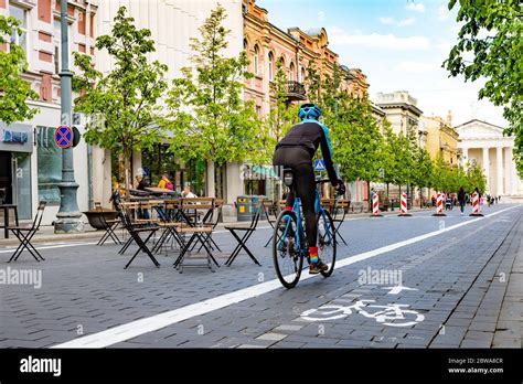 Rider cycling on the road bike in Vilnius city center reopening with ...