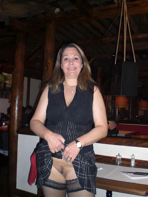 Milf In A Short Skirt And Stockings Inside A Restaurant And Showing Her Pussy