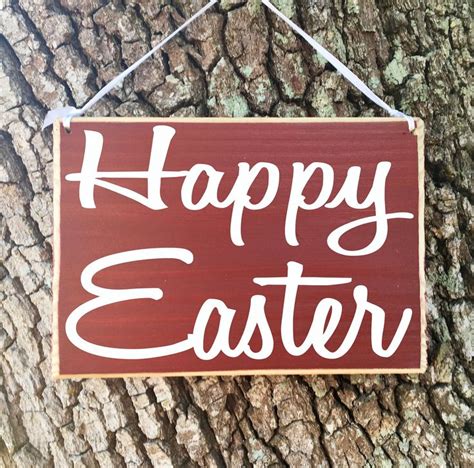 A Wooden Sign That Says Happy Easter Hanging On A Tree