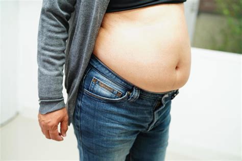 Asian Woman Show Fat Belly Big Size Overweight And Obesity At Office