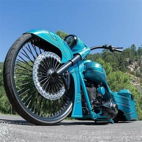 Blue Motorcycle Parked on Road